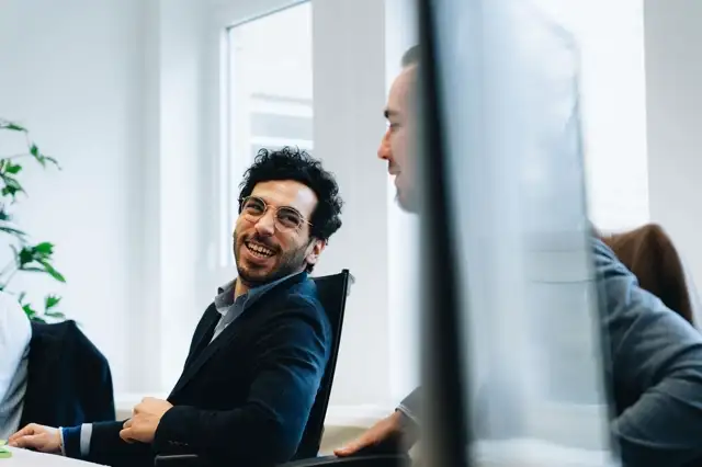 Two team members at Sander's offices discussing together